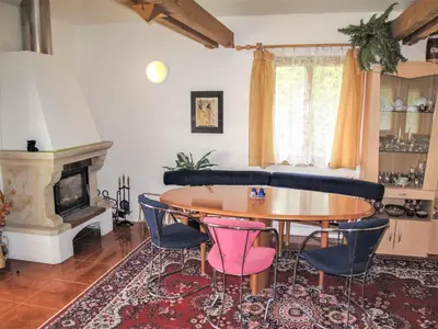 a living room with a table and chairs and a fireplace at Villa Petříkov by Interhome in Petříkov