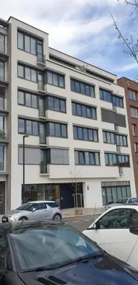a large building with cars parked in front of it at Vikys Apartment in Prague