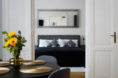 a bedroom with a bed with a mirror and a table at Apartment Dusni Superior in Prague