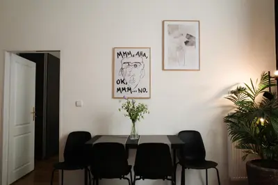 a dining room with a table and black chairs at Apartment Dusni Superior in Prague