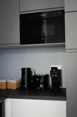 a kitchen with three microwaves and a microwave at Apartment Dusni Superior in Prague