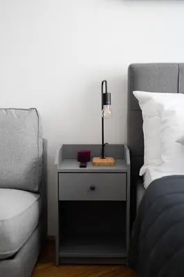 a nightstand with a lamp on it next to a bed at Apartment Dusni Superior in Prague