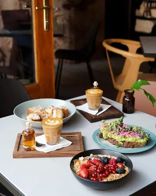 a table with plates of food and cups of coffee at Apartment Dusni Superior in Prague