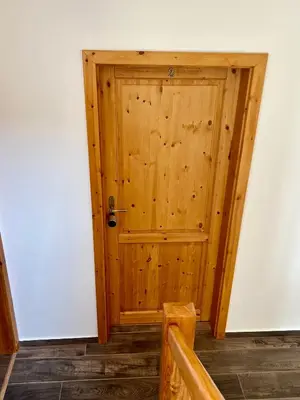 a wooden door in the corner of a room at Chalupa nad rybníkem in Straškov