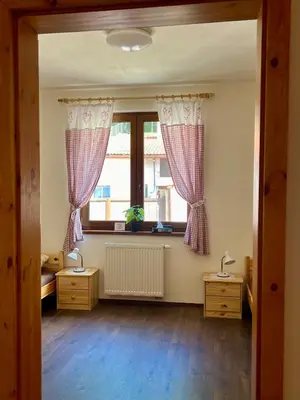 an empty room with a window and two lamps at Chalupa nad rybníkem in Straškov