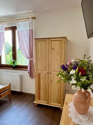 a room with a vase of flowers on a table at Chalupa nad rybníkem in Straškov