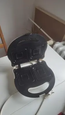 a black object sitting on top of a toilet at Nomads room nearest forest Kamýk in Prague
