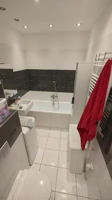a bathroom with a tub and a toilet and a sink at Nomads room nearest forest Kamýk in Prague