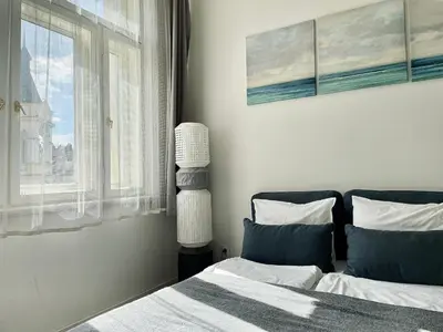 a bedroom with a bed and a window at JZP studio apartment in Prague