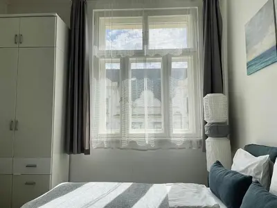 a bedroom with a bed and a window at JZP studio apartment in Prague