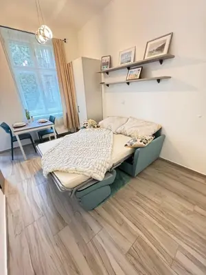 a bedroom with a bed and a table at Arbes 11 in Prague