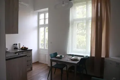 a kitchen with a table and chairs in a kitchen at Arbes 11 in Prague