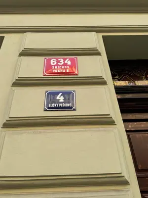a street sign on the side of a building at Arbes 11 in Prague