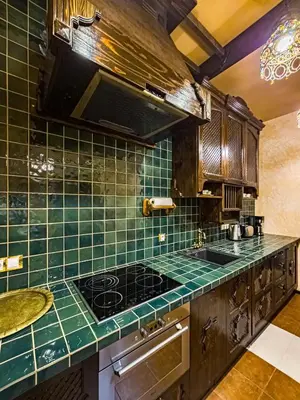 a kitchen with green tiled counters and a stove at 1000 and 1 night in Prague city center in Prague