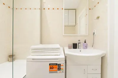 a white bathroom with a sink and a shower at 3-bedroom apartment for family in Prague