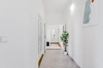 a hallway with white walls and a white hallway at 3-bedroom apartment for family in Prague