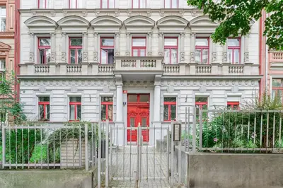 a building with a red door in front of it at 3-bedroom apartment for family in Prague