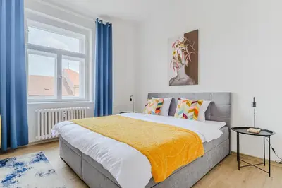 a bedroom with a large bed and a window at 3-bedroom apartment for family in Prague