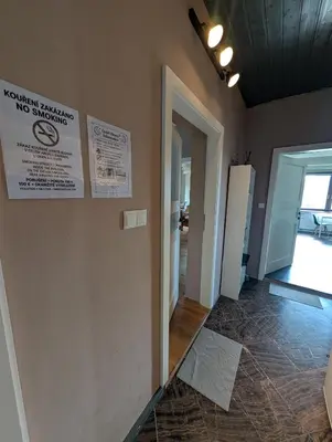 a bedroom with a desk and a bed and a lamp at Airport Private Apartment, Advance Registration, No Reception, Self Check-in, Calm Environment, Non-Smoking Guests in Kněžívka