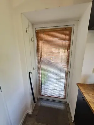 a small kitchen with a table and a table and a chair at Airport Private Apartment, Advance Registration, No Reception, Self Check-in, Calm Environment, Non-Smoking Guests in Kněžívka
