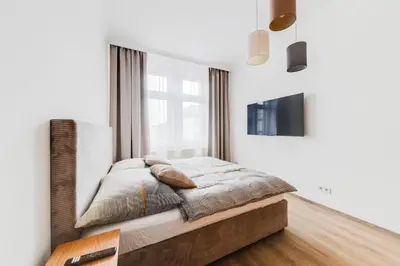 a bedroom with a bed and a window at One bedroom Apartment at Sokolovska in Prague