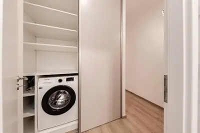 a laundry room with a washer and dryer at One bedroom Apartment at Sokolovska in Prague