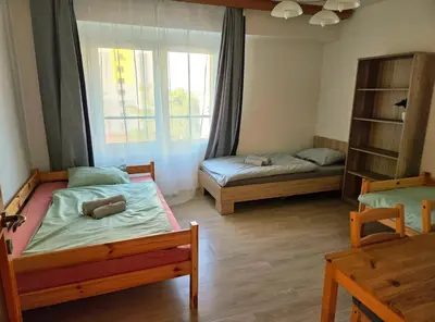 a bedroom with two beds and a window at Apartment in center of Poděbrady in Nymburk