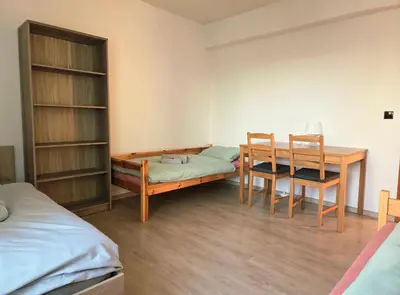 a room with a desk and a table and chairs at Apartment in center of Poděbrady in Nymburk