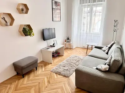 a living room with a couch and a tv at Viaduct View Apartment in Prague