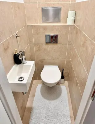 a bathroom with a toilet and a sink at Viaduct View Apartment in Prague
