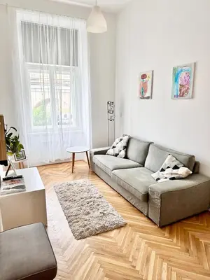 a living room with a couch and a rug at Viaduct View Apartment in Prague