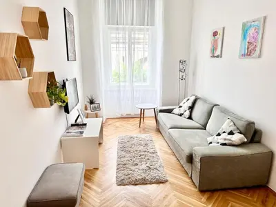 a living room with a couch and a table at Viaduct View Apartment in Prague