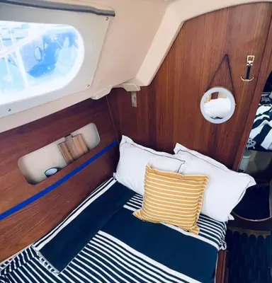 a bed in the back of a boat with pillows at Ubytování na plachetnici in Živohošť