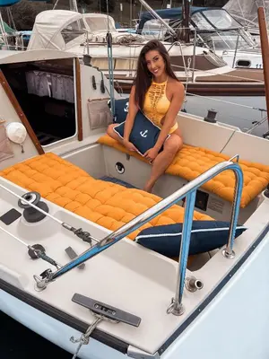 a woman sitting on the back of a boat at Ubytování na plachetnici in Živohošť
