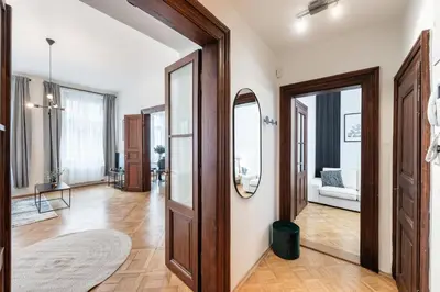 an open hallway with wooden doors and a living room at Prague City vibe apartment in Prague