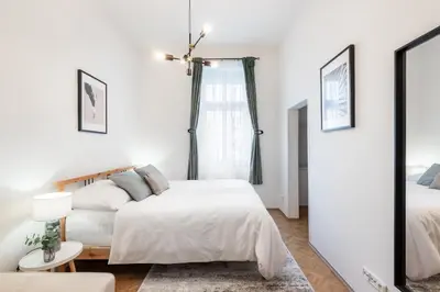 a bedroom with two beds and a mirror at Prague City vibe apartment in Prague