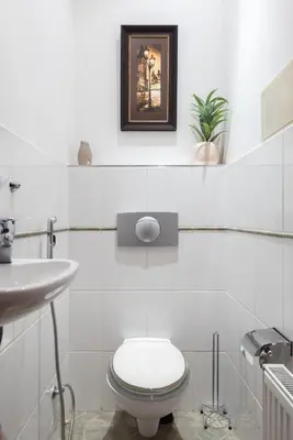 a white bathroom with a toilet and a sink at Prague City vibe apartment in Prague