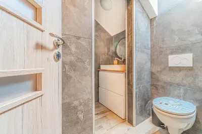 a bathroom with a toilet and a sink at Vila Sara s bazénem a infrasaunou na kraji Prahy in Zbuzany