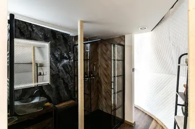 a bathroom with a shower with a glass door at Tiché místo Glamping in Slapy