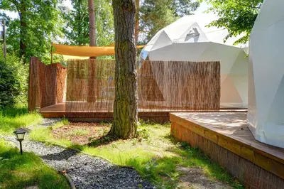 a pavilion with a tree in a yard at Tiché místo Glamping in Slapy
