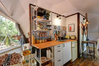 a kitchen with a counter and a sink in a room at Tiché místo Glamping in Slapy