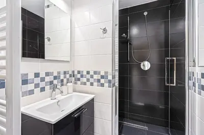 a bathroom with a sink and a shower at Oasis Apartments at Charles Square in Prague