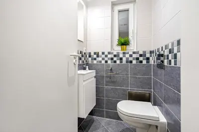 a bathroom with a toilet and a sink at Oasis Apartments at Charles Square in Prague