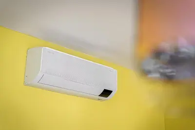 a white object is attached to a yellow wall at Oasis Apartments at Charles Square in Prague