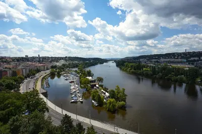 an aerial view of a river with boats docked at Luxury riverside apartment in Prague