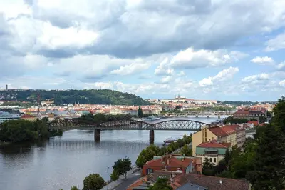a view of a bridge over a river with buildings at Luxury riverside apartment in Prague
