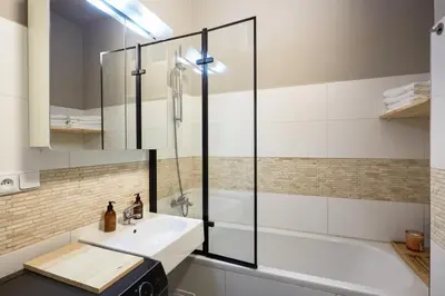 a bathroom with a sink and a shower at Luxury riverside apartment in Prague