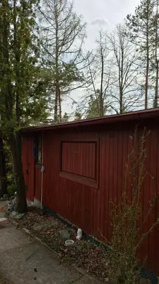 a wooden shed with a table and a bowl on it at Lesní chata v Malé Hraštici in Malá Hraštice
