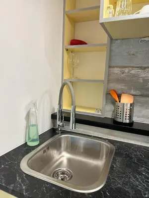 a kitchen counter with a sink in a kitchen at Mini Apartman - G - Vyhlídka nad řekou in Zámky