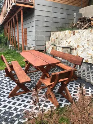 a wooden picnic table and bench next to a building at Mini Apartman - G - Vyhlídka nad řekou in Zámky